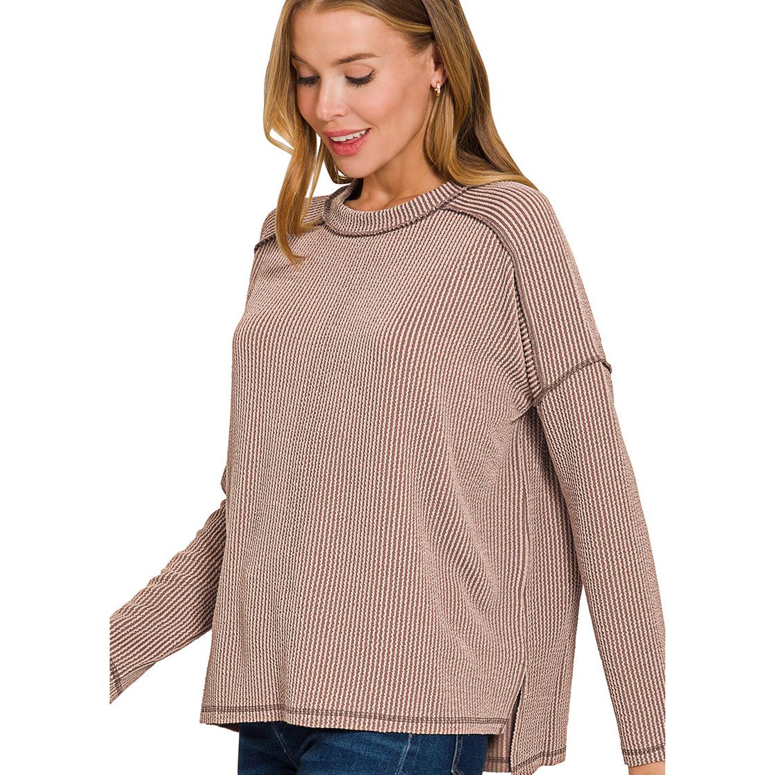 Woman wearing a brown ribbed sweater on a white background