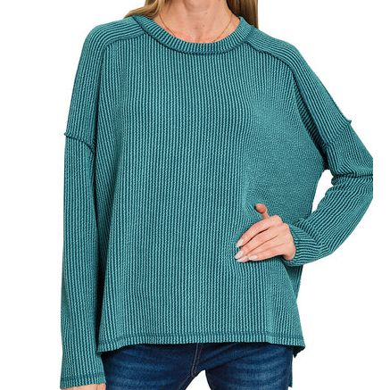 Woman wearing a teal sweater on a white background