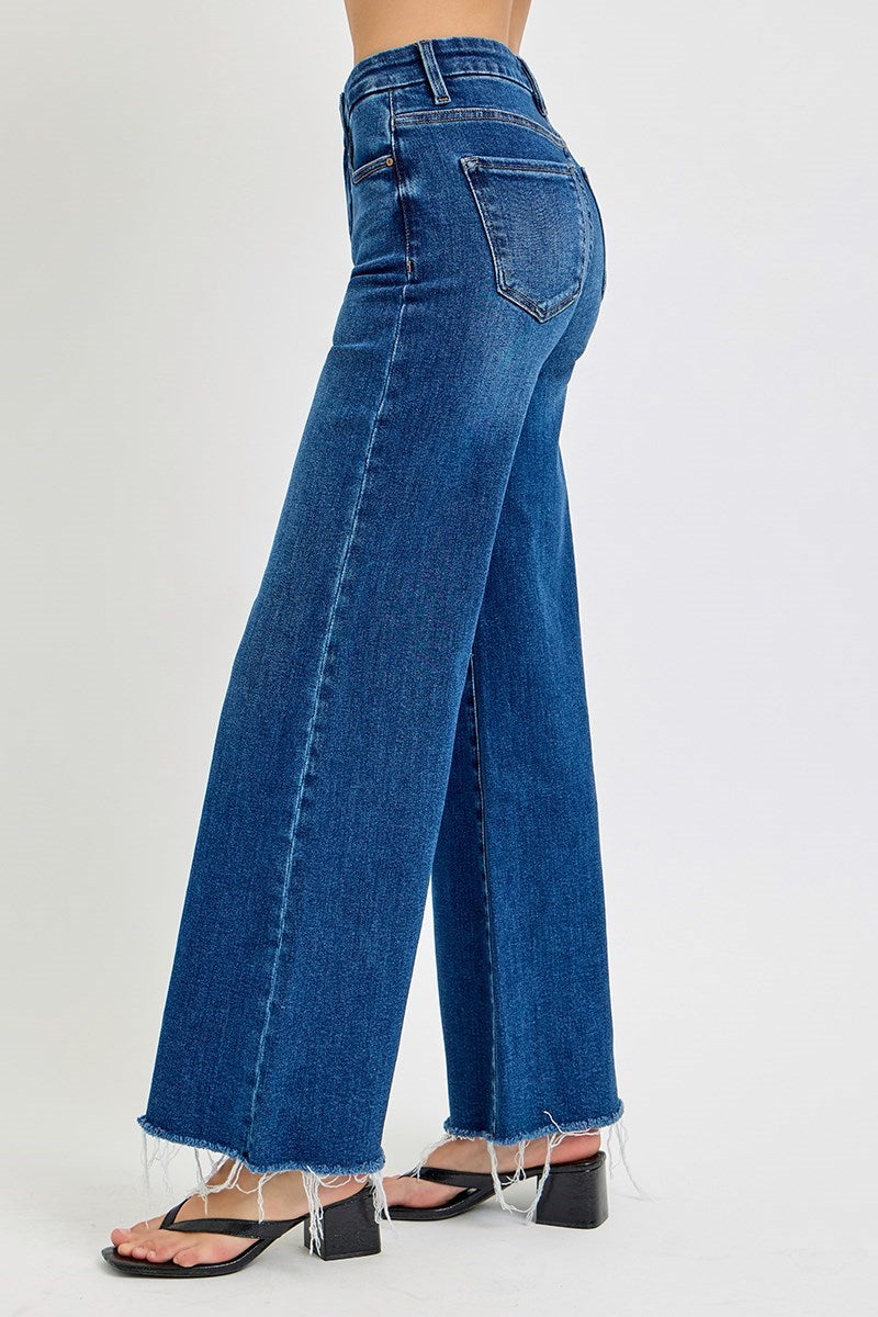 Risen Poppy Dark Blue jeans worn by a person on a white background