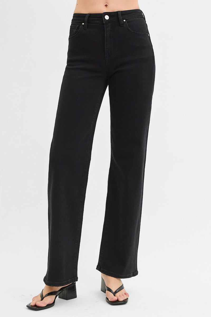 Black jeans worn by a person on a white background