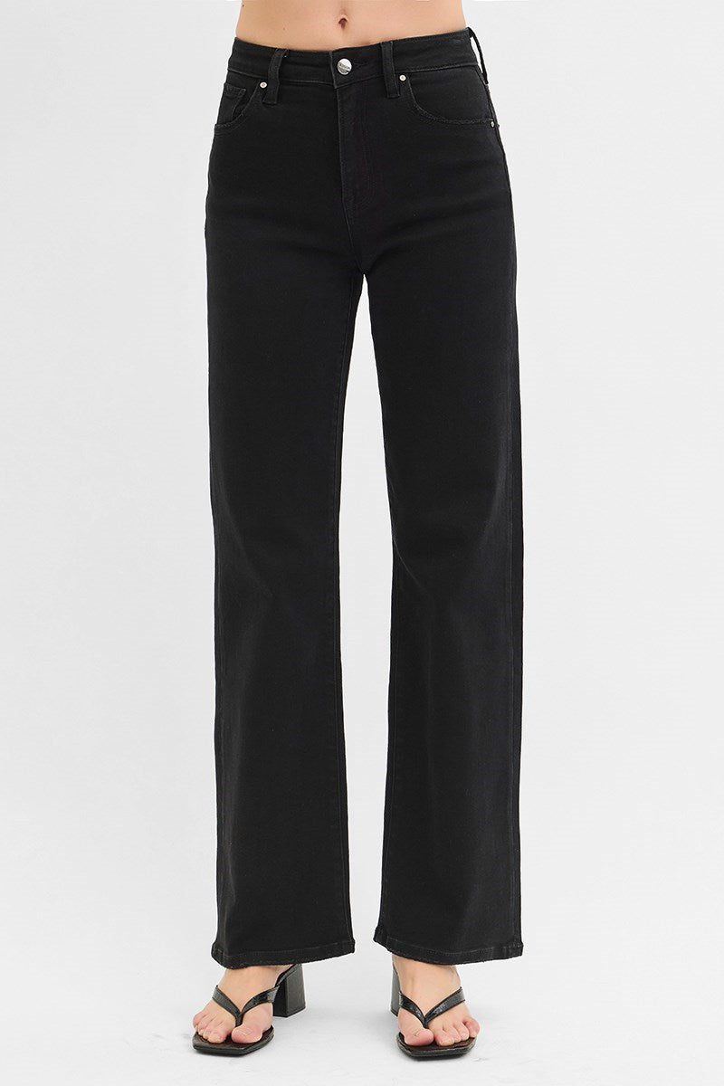 Black jeans worn by a person on a white background