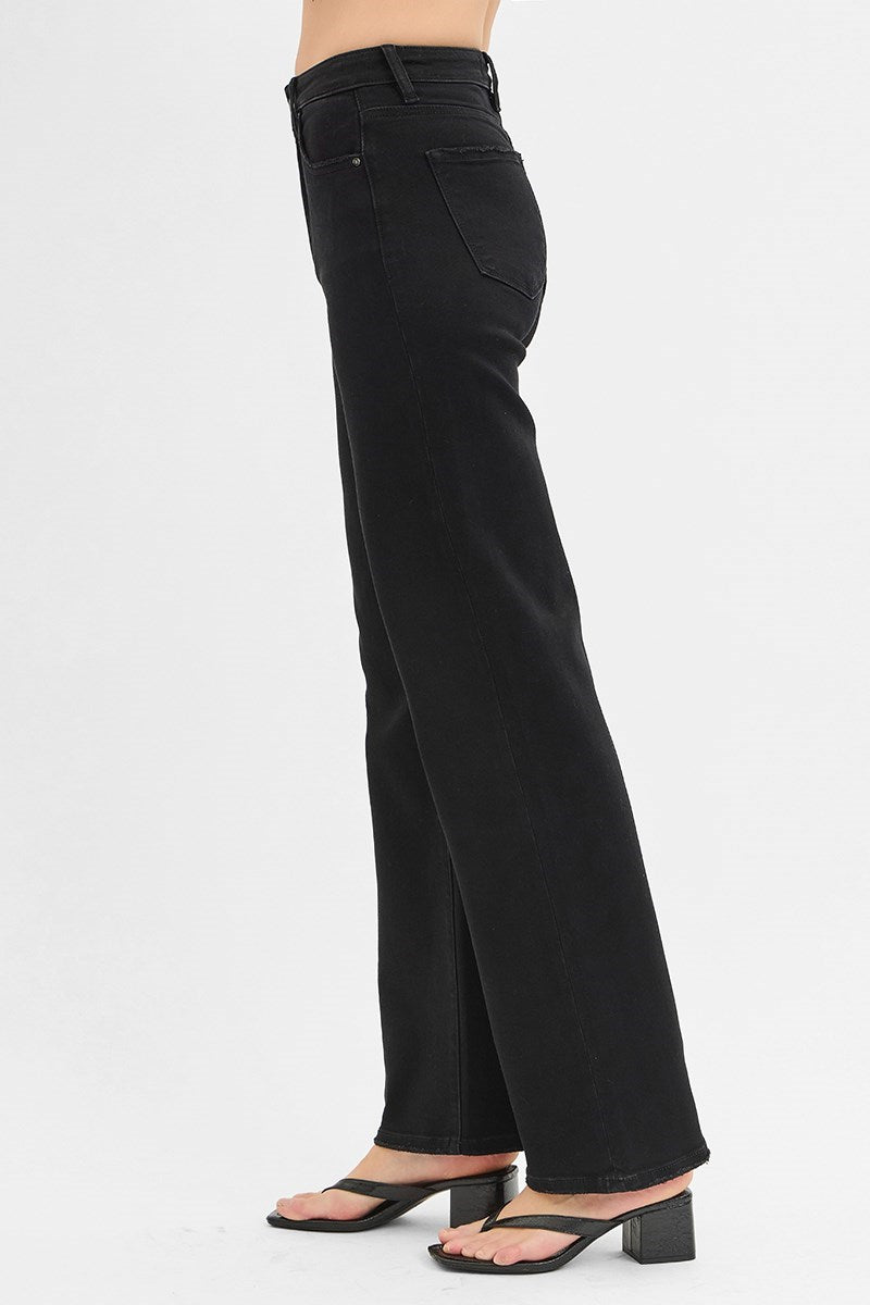Black wide-leg jeans worn by a person on a white background