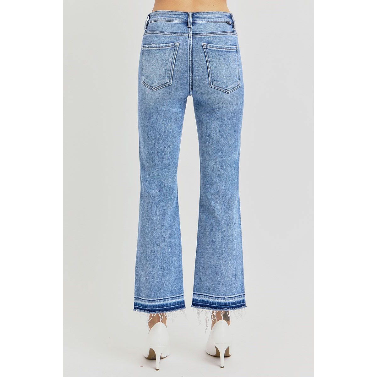 Blue jeans, High rise straight leg with raw, shadow-detailed hem worn by a person on a white background