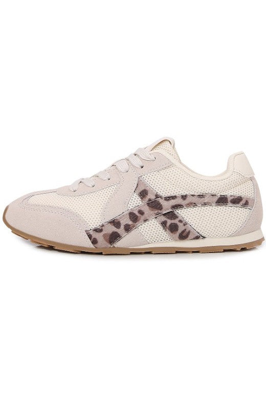 White sneaker with leopard print accent on a white background