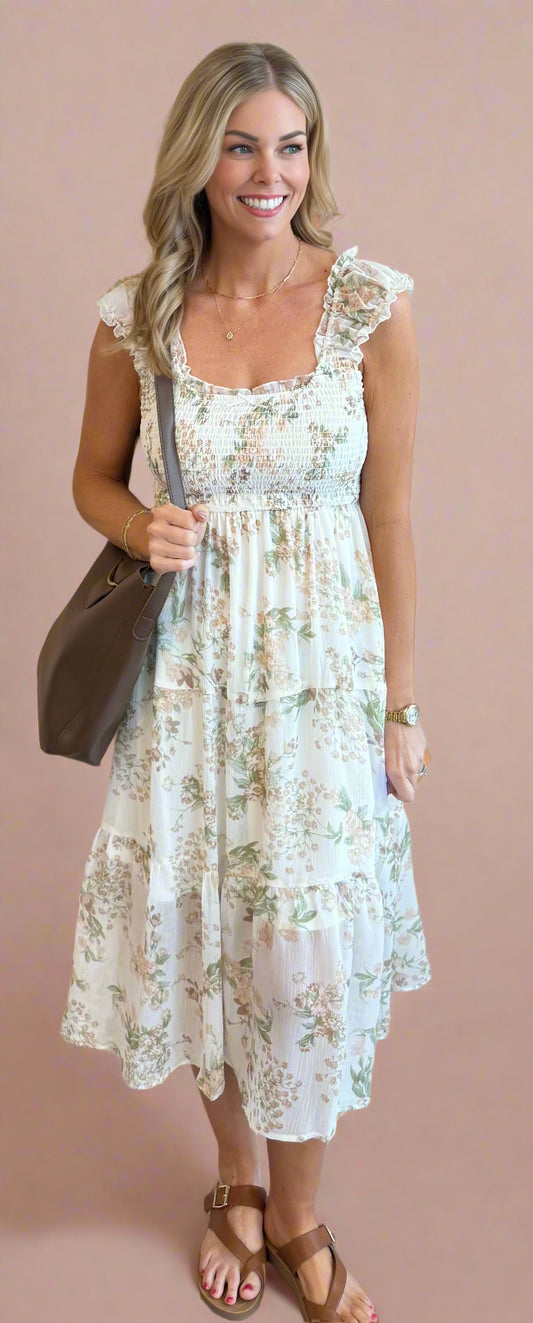 Woman wearing a floral dress against a beige wall