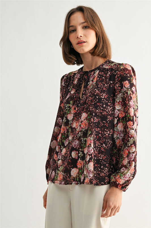 Woman wearing a floral blouse with a plain background