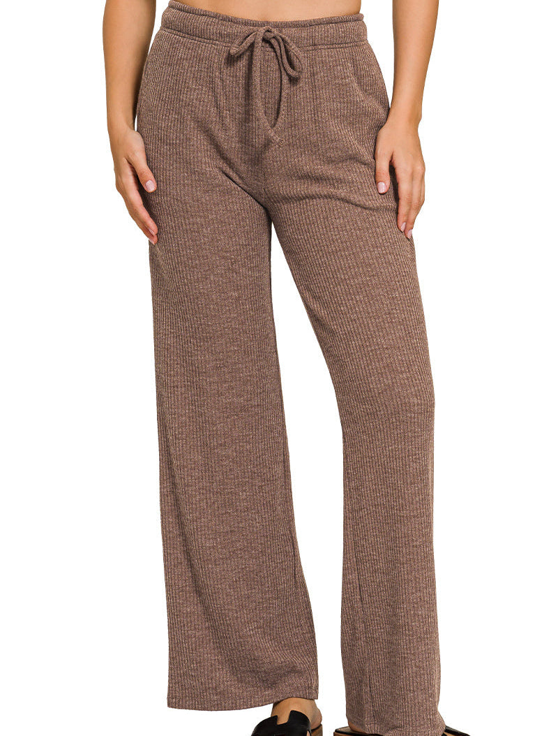 Brown ribbed pants worn by a person on a white background