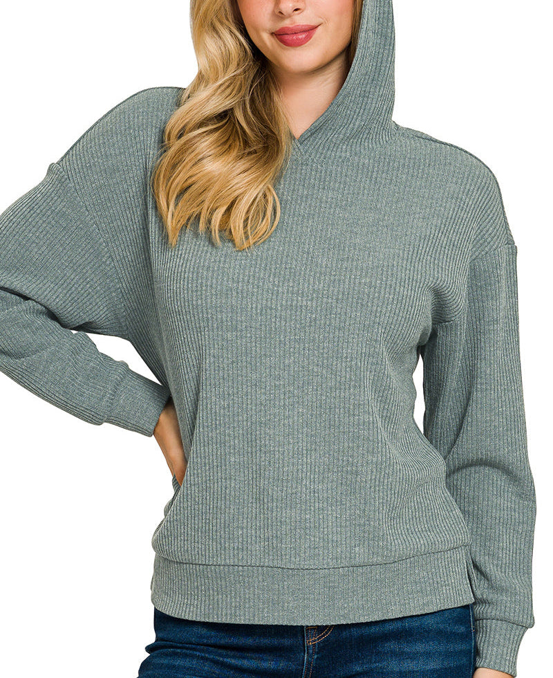 Woman wearing a green ribbed hoodie on a white background