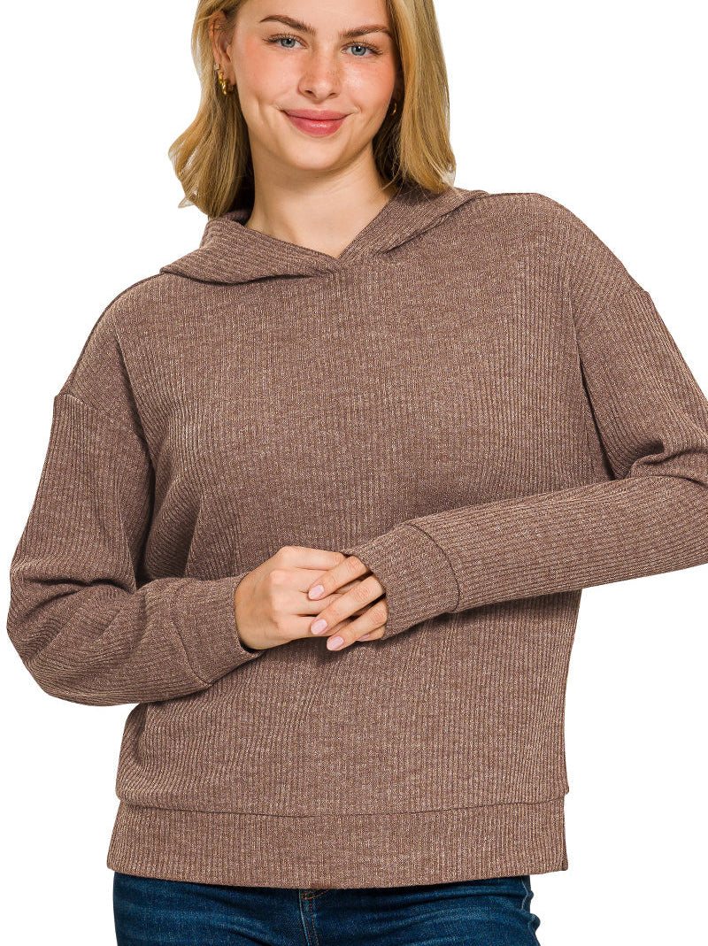 Woman wearing a brown ribbed hoodie on a white background