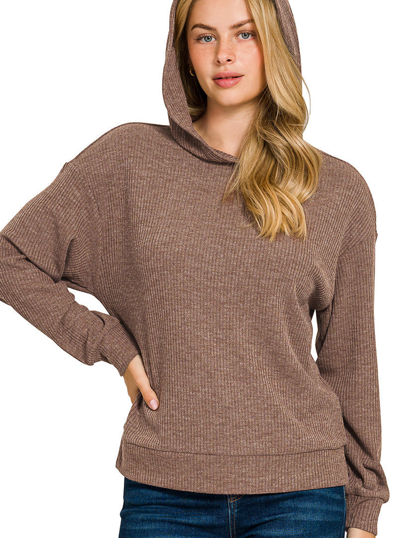 Woman wearing a brown ribbed hoodie on a white background