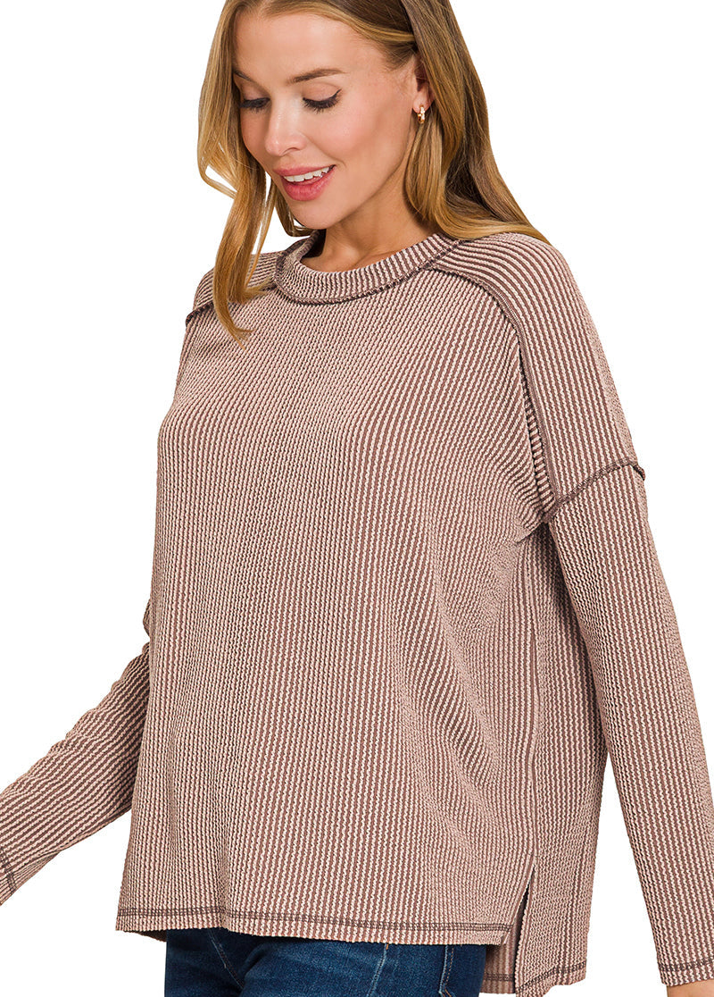 Woman wearing a brown ribbed sweater on a white background