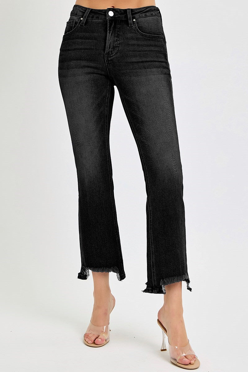Black jeans worn by a person on a white background