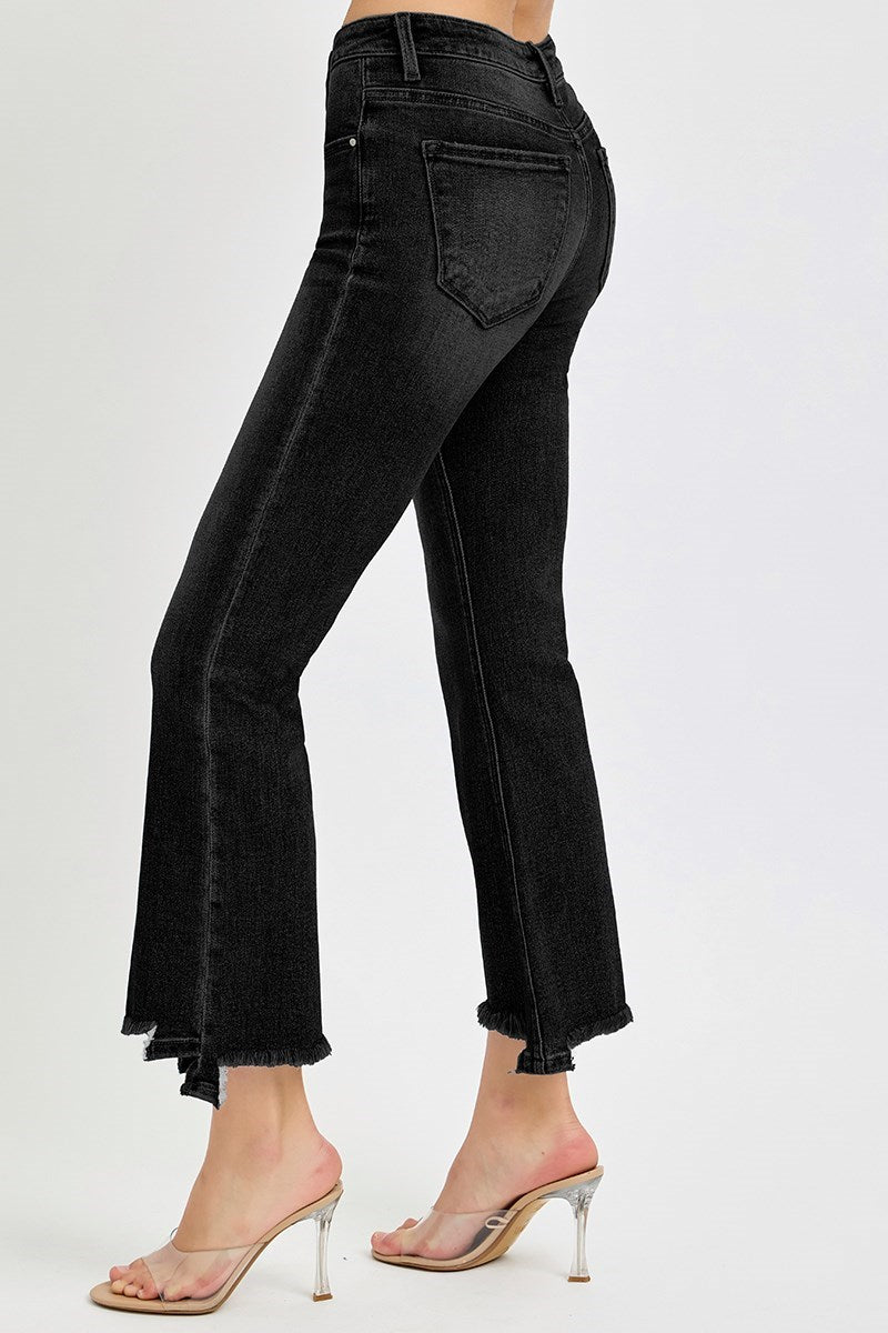 Woman wearing black risen brighton jeans with a ragged hem on a white background