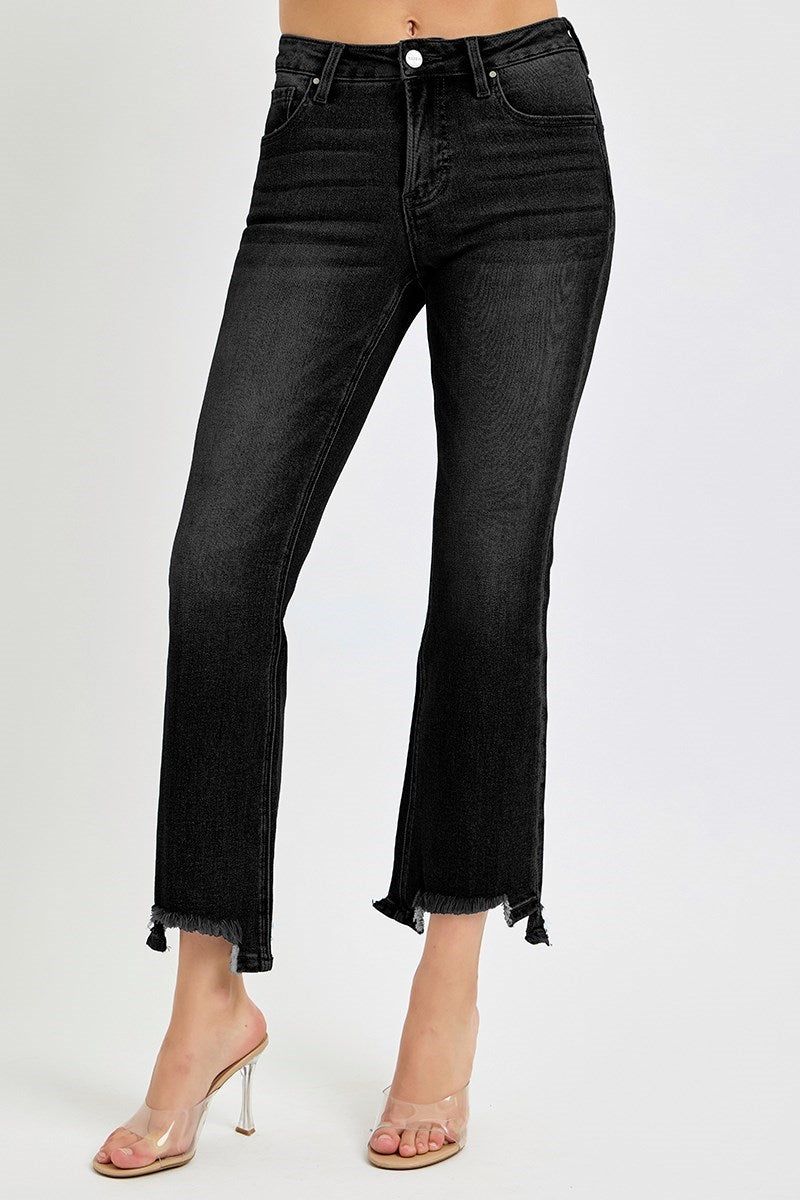 Woman wearing black risen brighton jeans with a ragged hem on a white background