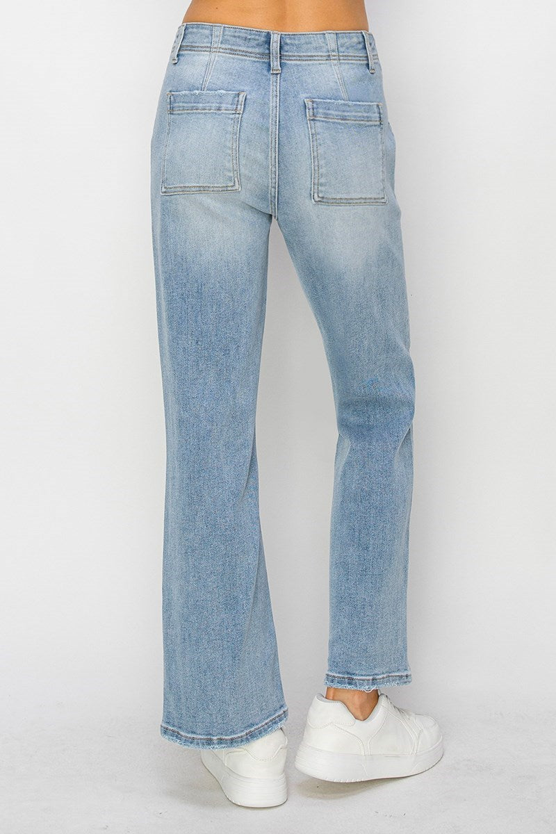 Light blue jeans with a high ankle hem worn by a person on a white background