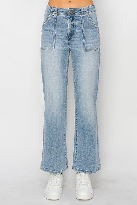 Light blue jeans with a high rise ankle hem worn by a person on a white background