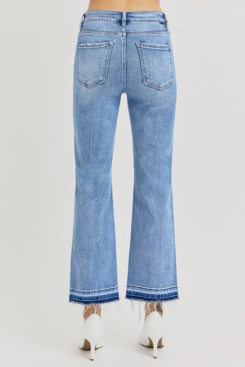 Blue jeans, High rise straight leg with raw, shadow-detailed hem worn by a person on a white background 