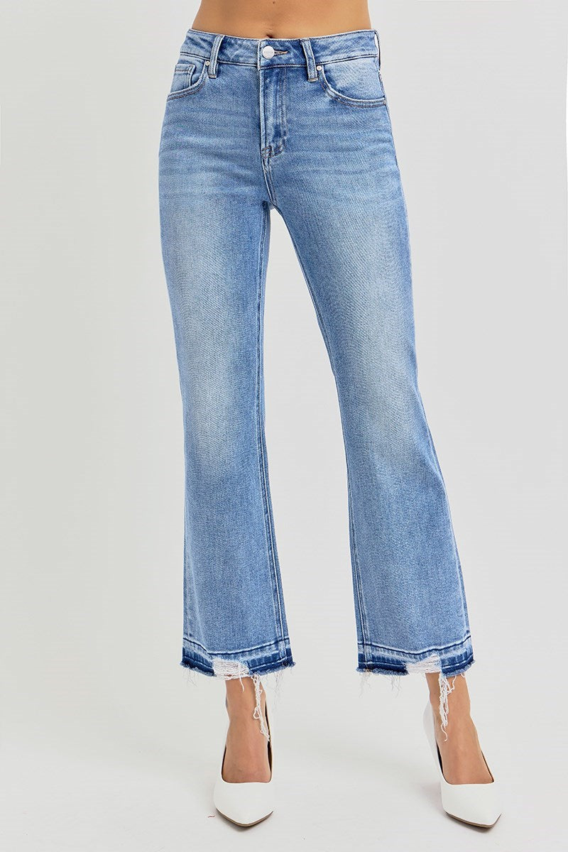 Blue jeans, High rise straight leg with raw, shadow-detailed hem worn by a person on a white background 