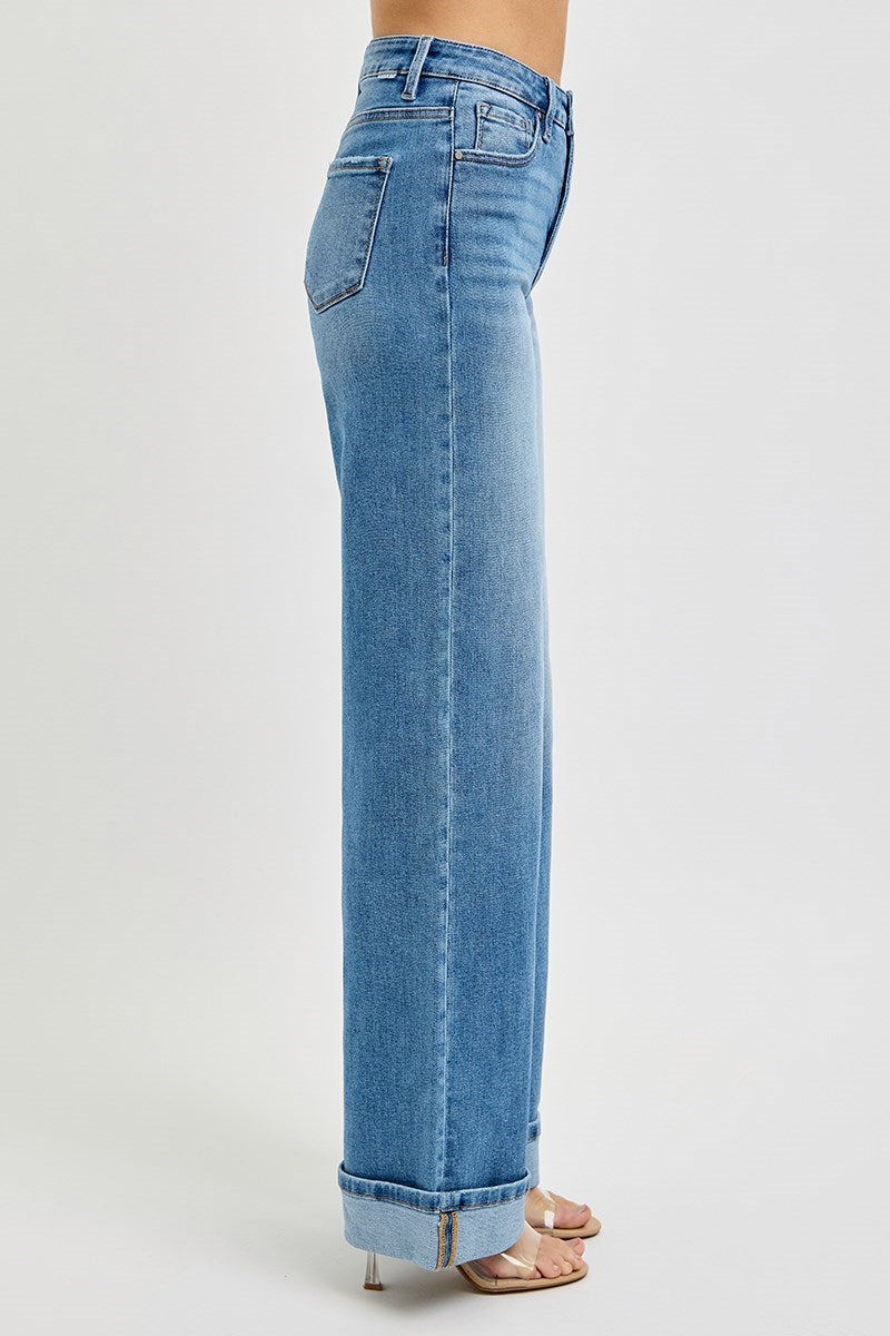 Blue jeans worn by a person on a white background