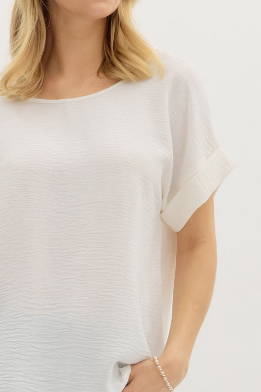 White blouse worn by a person on a white background